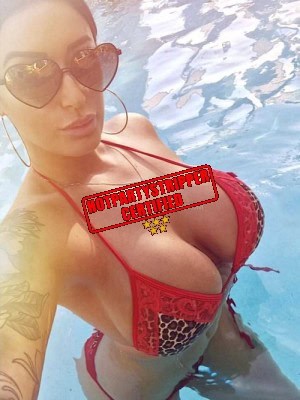 beautiful latina in a swimming pool with big breasts in a red bikini